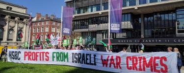 Campaigners protest at HSBC's 2018 AGM, holding a giant banner reading "HSBC profits from Israeli war crimes".